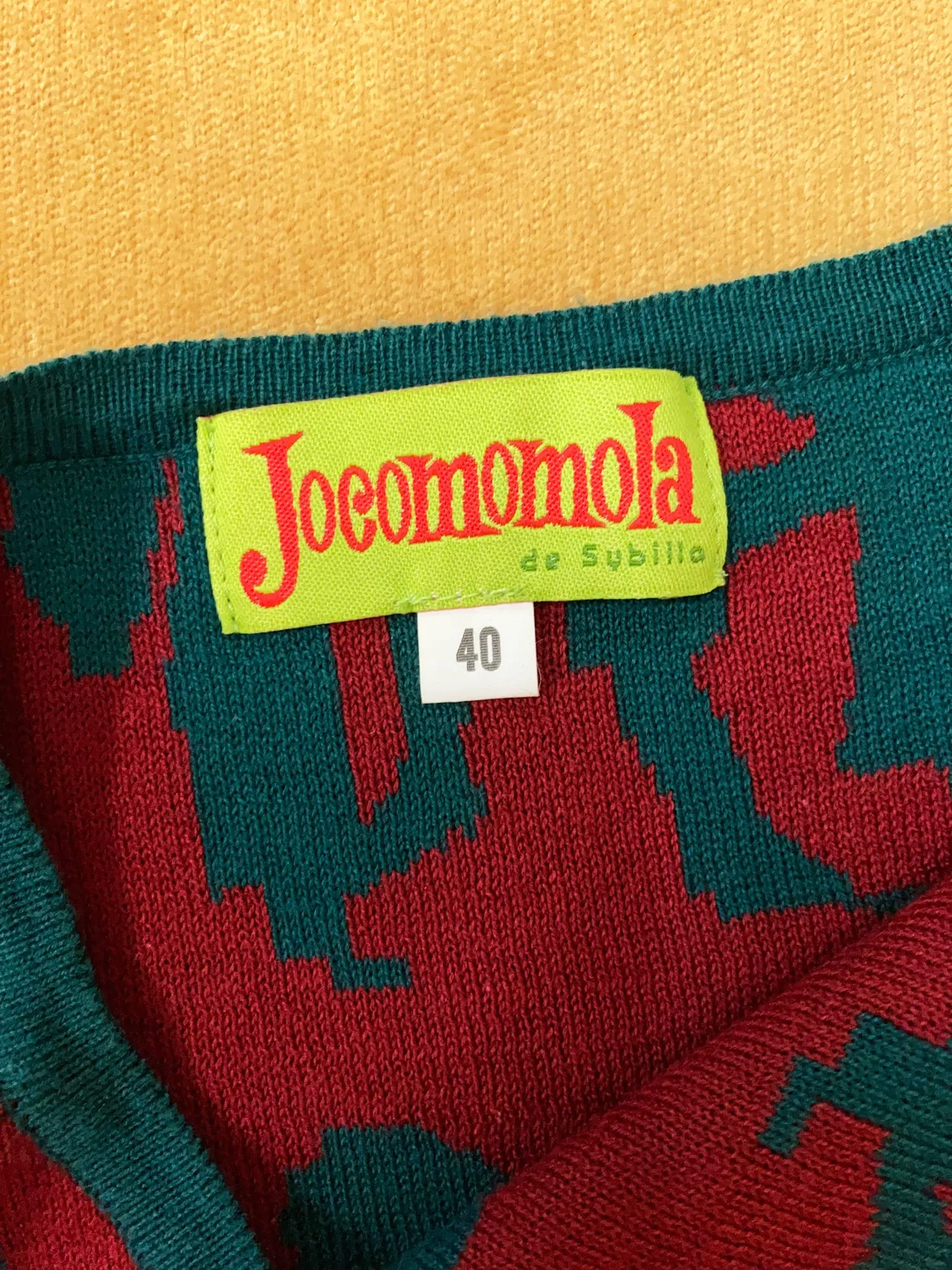 Jocomomola de Sybilla green knitted cotton vest with red dancing figures